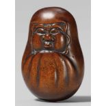 A boxwood netsuke of a Daruma roly-poly-doll, by Masakazu. 19th centuryOf flattened shape, the