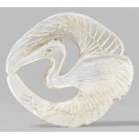 A mother-of-pearl netsuke of a crane. 19th centuryOf flat shape, with finely engraved eye area, beak