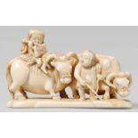 An okimono-type ivory netsuke of two herdboys with oxen, by Hôshinsai. Second half 19th centuryOne