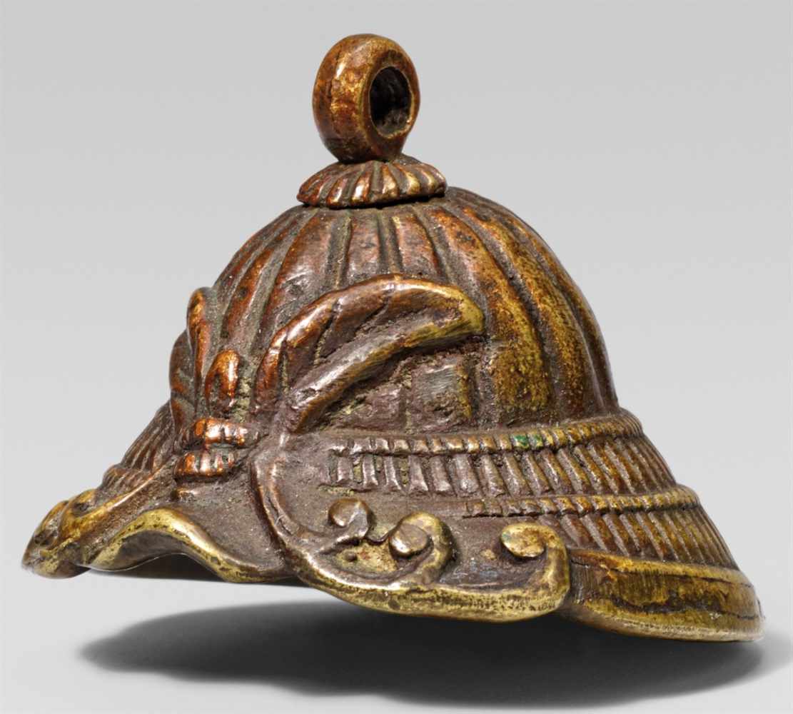 A brass ashtray netsuke of a kabuto. 19th centuryCast with a stylised insect forming the helmet