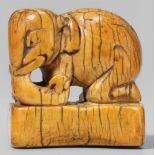 An ivory netsuke of an elephant. 17th/18th centuryKneeling on a rectangular base, the head