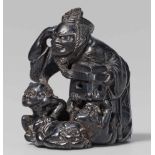 An ebony wood netsuke of a toshiotoko at setsubun, by Gyokusen. Early 19th centuryThe toshiotoko,