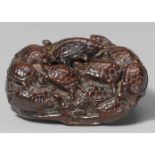 A reddish-brown wood netsuke of a group of fifteen tortoises, by Yôzan. Early 19th centuryPartly