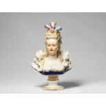 A Meissen porcelain bust of a ladyBust of an elegant lady in a feather headress on a round plinth,