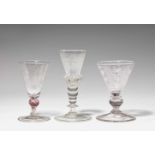 Three Bohemian glass gobletsClear glass goblets, one with round cut motifs, one with red thread