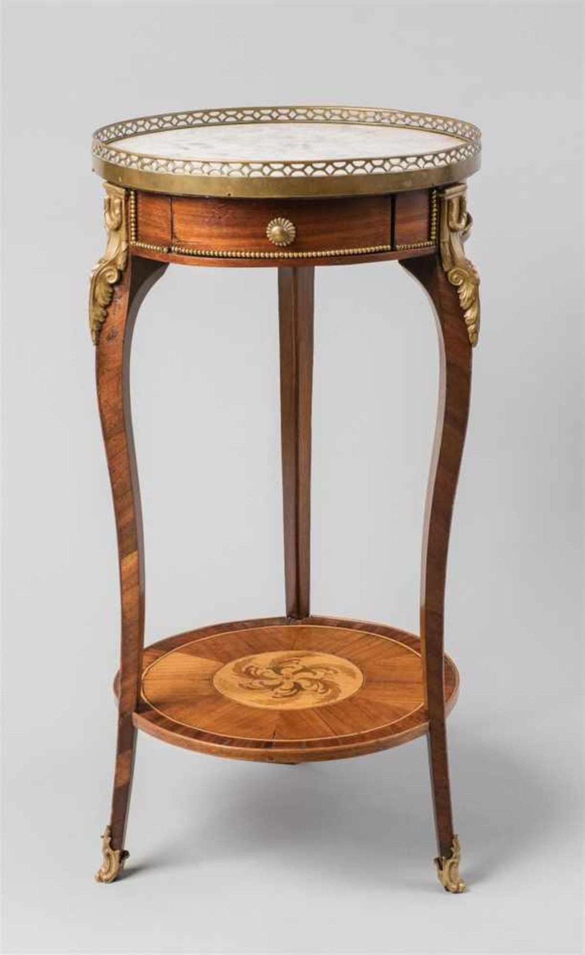 A Parisian Louis XVI gueridonMahogany, lemon wood, and ebonised fruitwood veneer on oak corpus