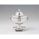 A silver boxFluted oval dish with slip lid on four spherical supports, decorated throughout with