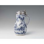 A Delftware pitcher with Danish silver mountingsPear-form faience jug with blue and white