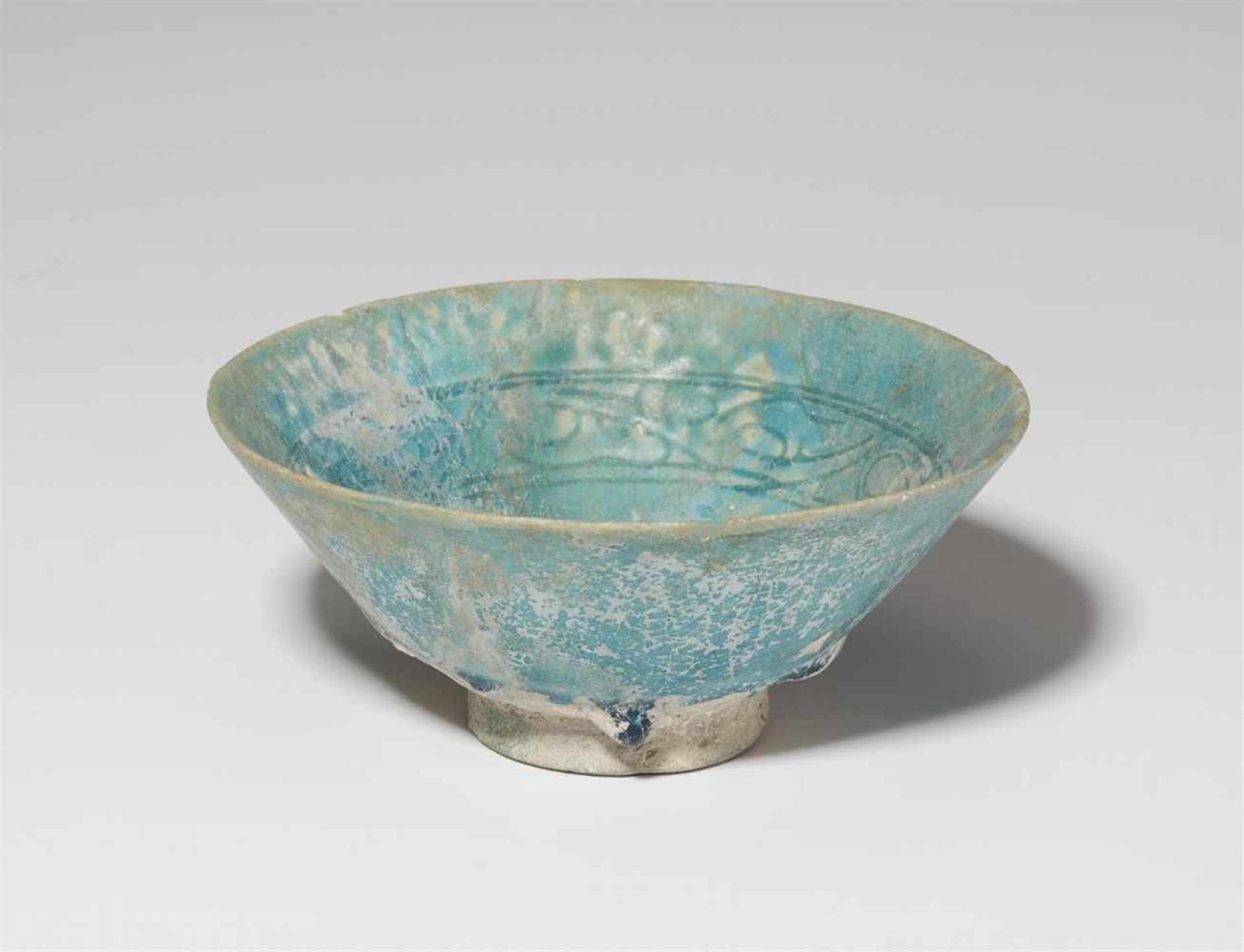 An Iranian engraved fritware bowlQuarz frit with iridescent turqoise glaze over a band of stylised