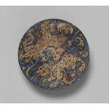 An Iranian fritware bowl with lion decorQuarz frit bowl with black decor on blue ground under