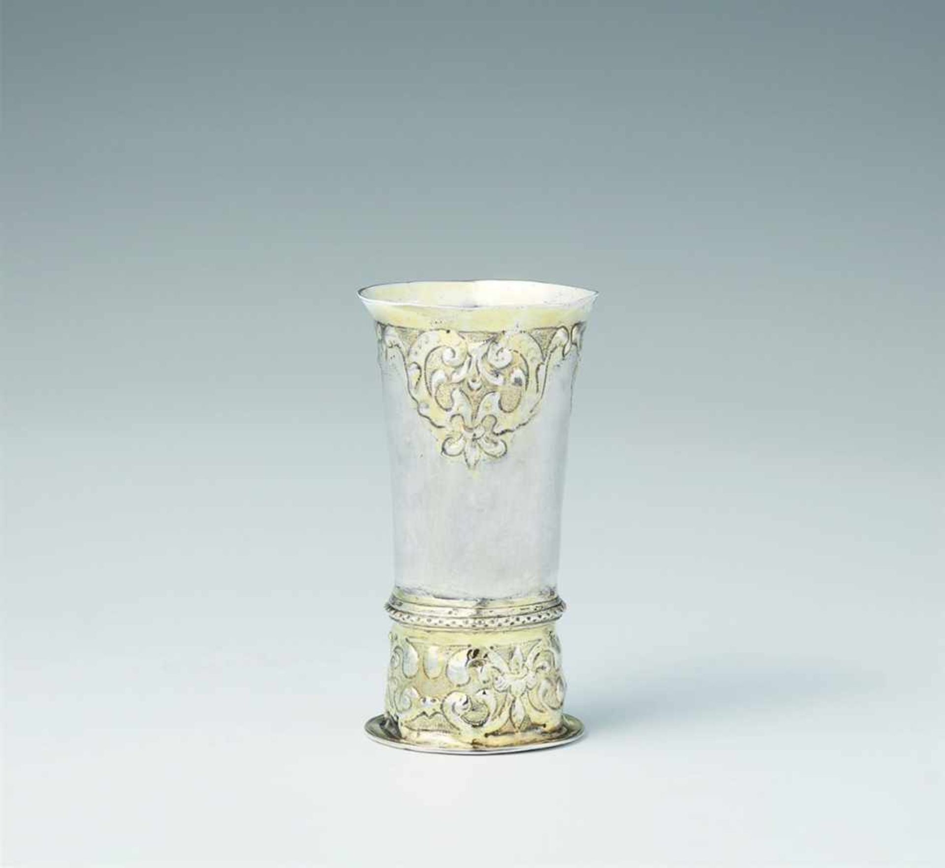 A Siebenbürgen parcel gilt silver "kluftbecher"Narrow tapering beaker on a tall base decorated