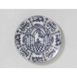 A Dutch Delft faience platter with architectural decorPainted to the centre with a depiction of a