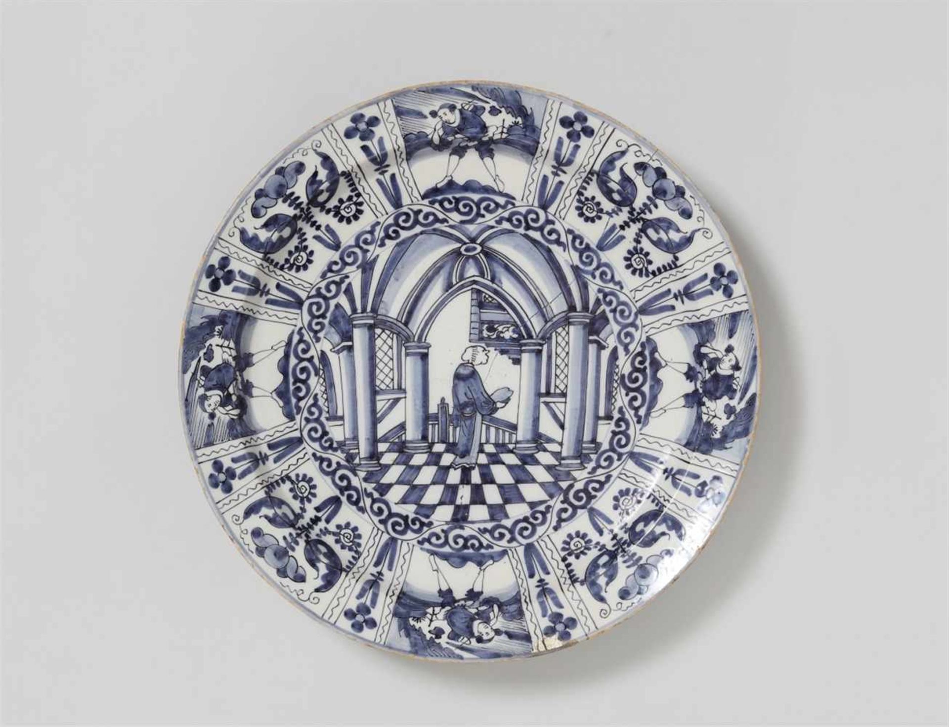 A Dutch Delft faience platter with architectural decorPainted to the centre with a depiction of a