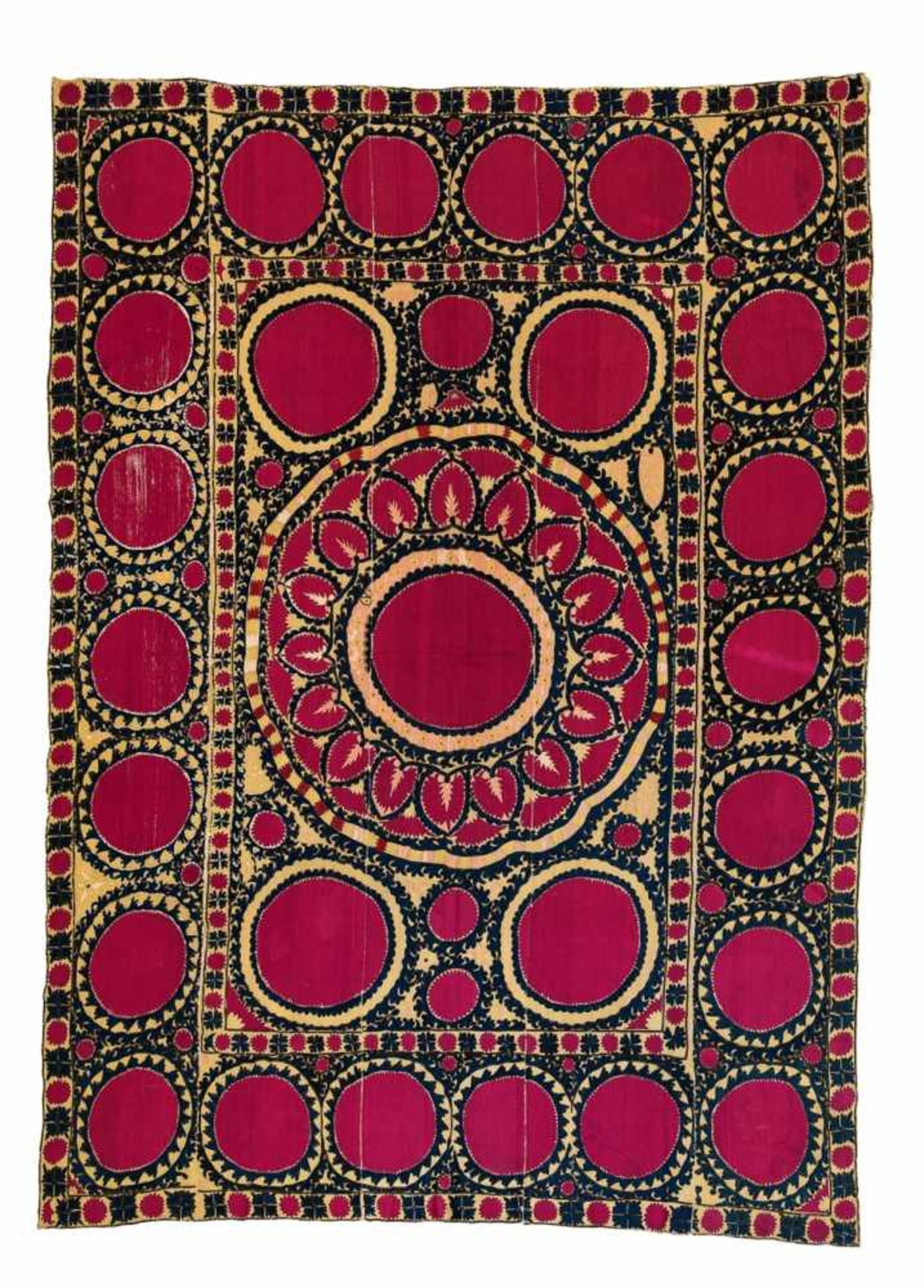 A Suzani embroideryComprising four cotton lengths sewn together, with magenta disc and dark blue