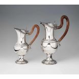 A pair of Augsburg silver wine pitchersPear-shaped corpus on waisted foot with hinged lid and