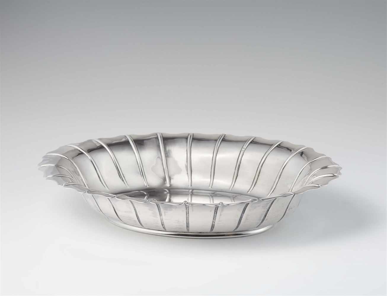 A George III silver dishA fluted oval shaped solid silver bowl. W 37; D 27.5; H 6.5 cm, weight 1,029