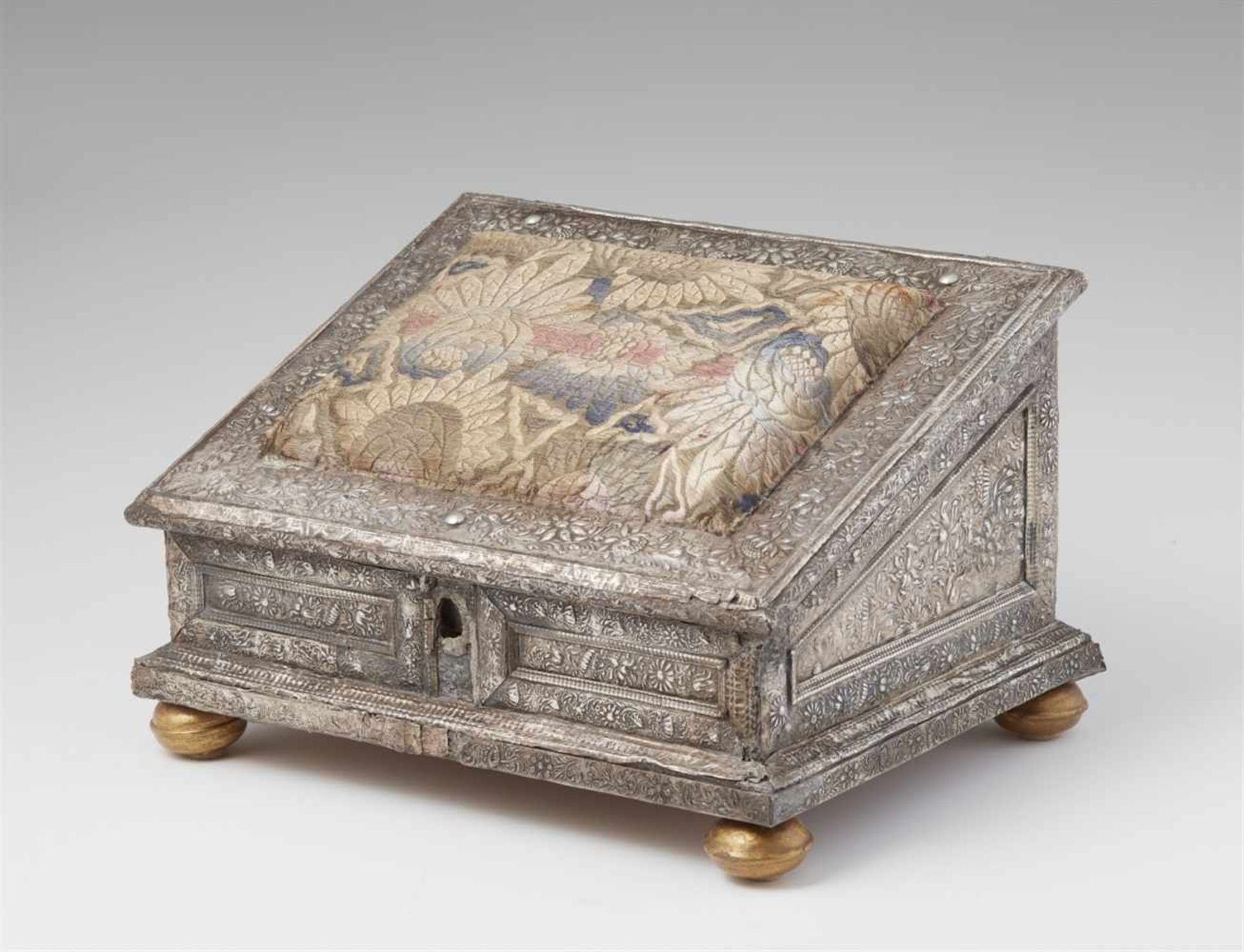 A Baroque silver sewing boxEmbossed silver, palisander and walnut veneer over wooden corpus. Lined