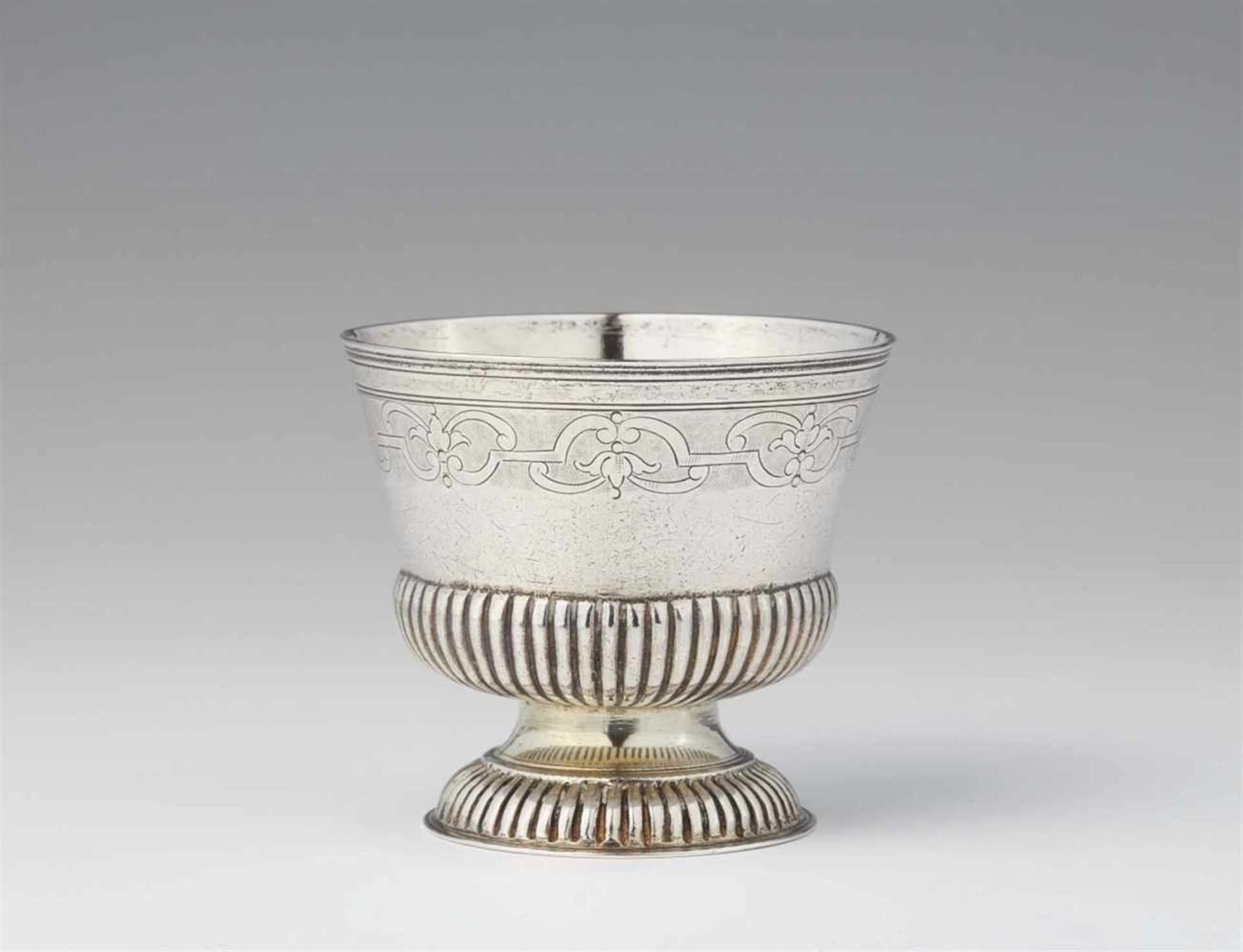 An Augsburg Régence silver beakerGadrooned silver beaker with remains of gilding and engraved