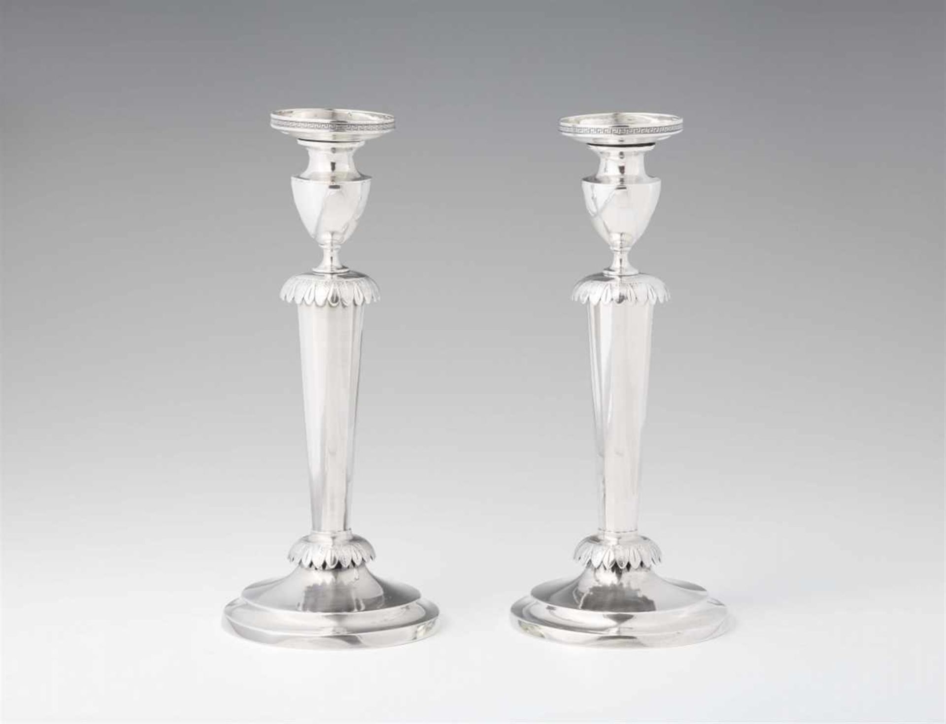 A pair of Kassel silver candlesticksRound bases supporting fluted tapering shafts with palmette form