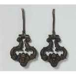 A pair of North Italian bronze door knockersDark brown patinated bronze door knockers with wrought