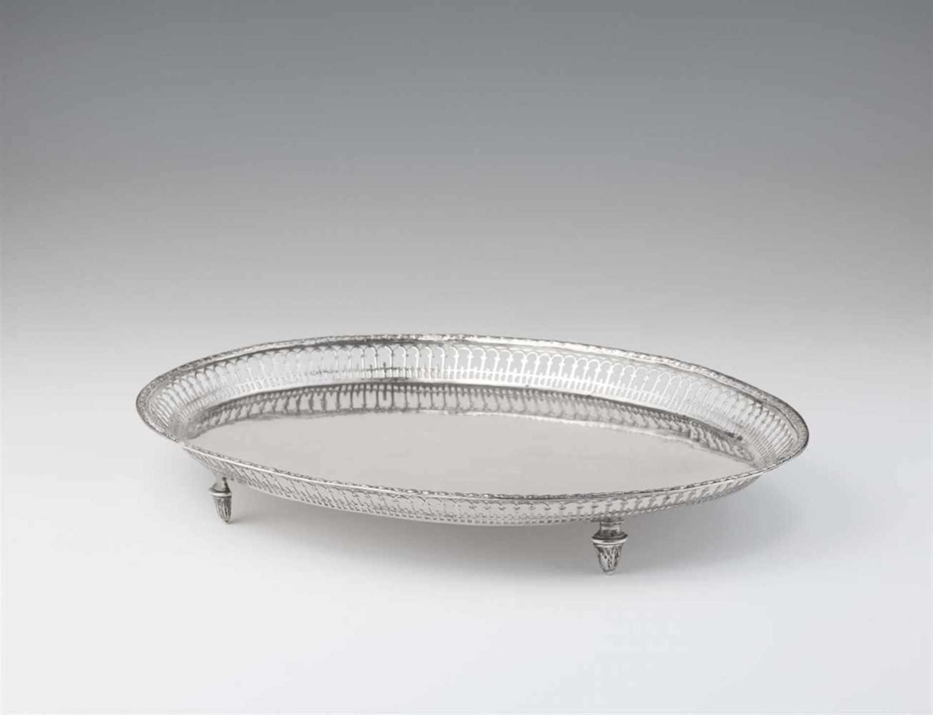 A Neoclassical Augsburg silver platterOval tray on four supports with pierced gallery rim. L 35.5; W