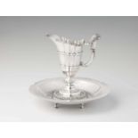 An Italian silver pitcher and basinFluted jug with curved handles and shell-shaped thumbrest. The