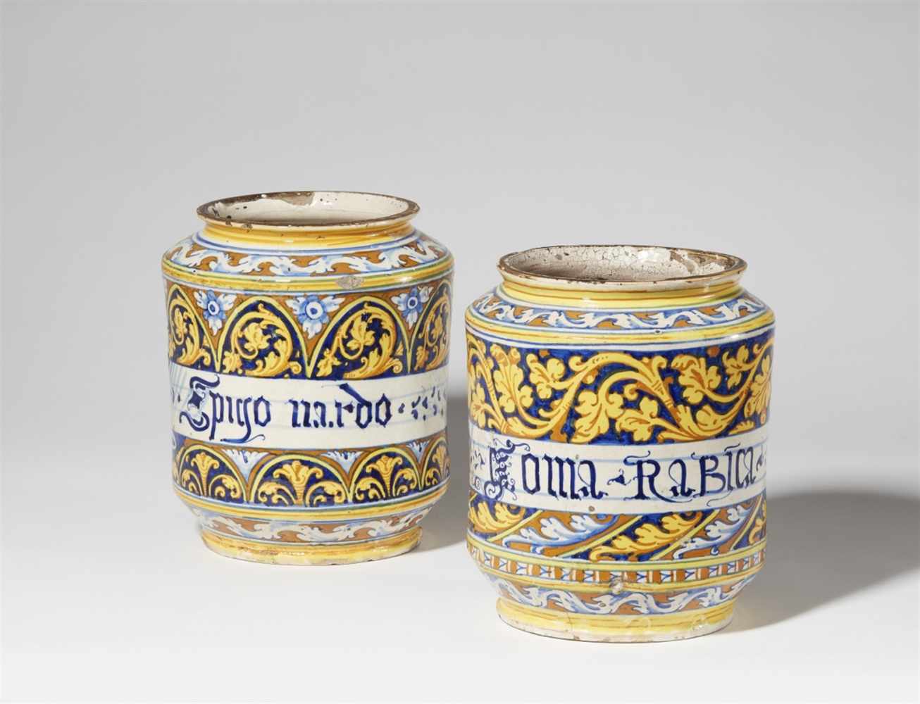A pair of Italian majolica albarelliSquat cylindrical form with waisted neck, one inscribed "Goma