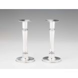 A pair of Art Deco silver candlesticksSmooth shafts on round bases, cylindrical nozzles with wide