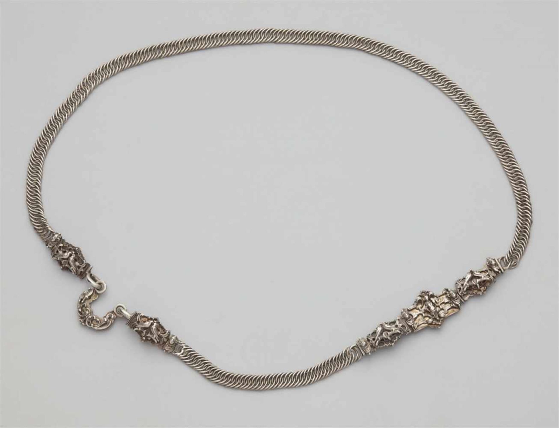 A Nuremberg silver bridal beltDesigned as a flat narrow chain, the cast silver decorative clasp