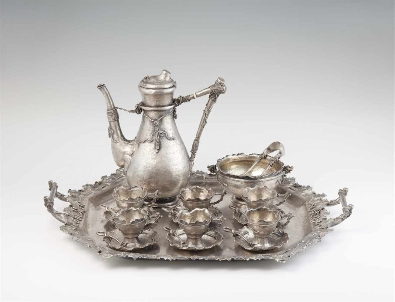 A Vienna silver trompe l'oeil serviceComprising a mocca pot, six cups with fixed saucers, six coffee