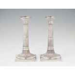 A pair of Neoclassical Augsburg silver candlesticksFluted column shafts resting on square plinths. H