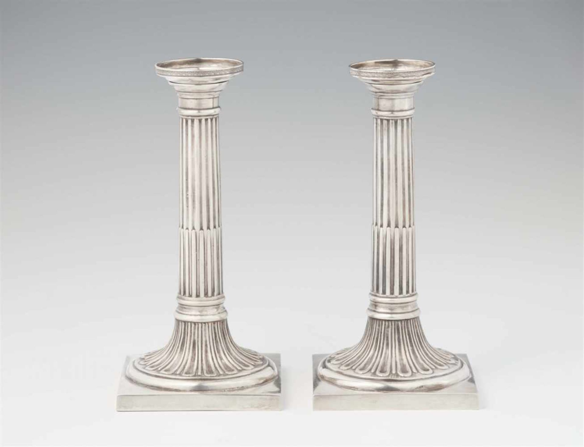 A pair of Neoclassical Augsburg silver candlesticksFluted column shafts resting on square plinths. H