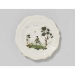 A faience plate with a hunting motifOf scalloped form with finely painted decor. Unmarked. D 24.2