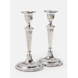A pair of George III silver candlesticksFlared fluted candlesticks on filled bases. Height 29 cm