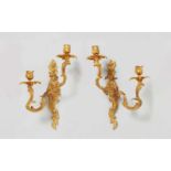 A pair of French Louis XV style ormolu appliquesTwo-flame appliques cast in one piece with
