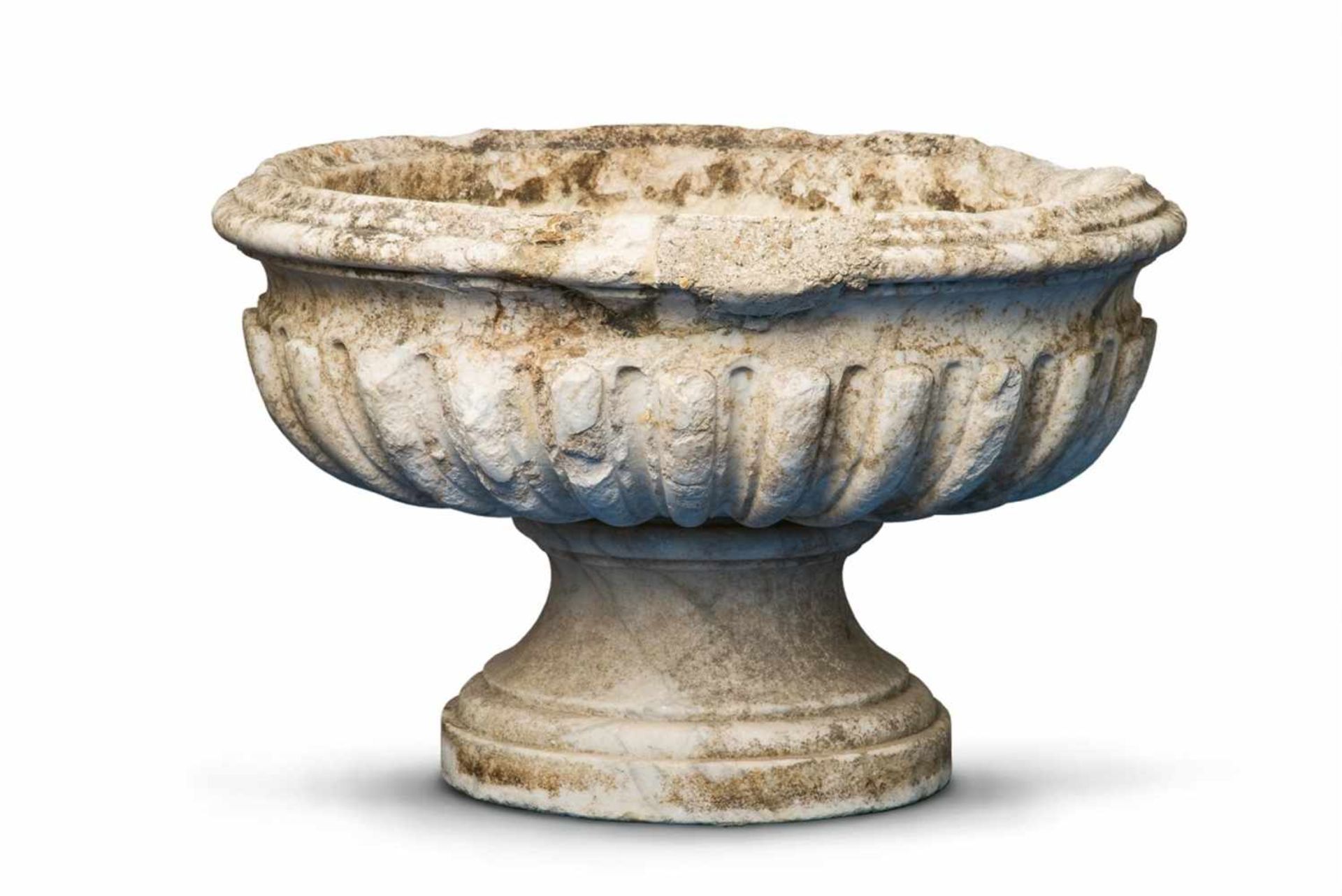 An oval white marble fountain basinTwo-part water fountain comprising a moulded bowl on a tapering