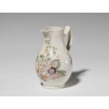 A faience pitcher with a basket of fruitDecorated to the display side with a particularly fine still