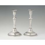 A rare pair of Turin silver candlesticksFluted shafts issuing from stepped bell-shaped bases. With