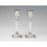 A pair of Frankfurt Empire silver candlesticksSquare plinths supporting tapering shafts with