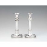 A pair of Brunswick silver candlesticksFestooned column shafts resting on square plinths. H 19.7 cm,