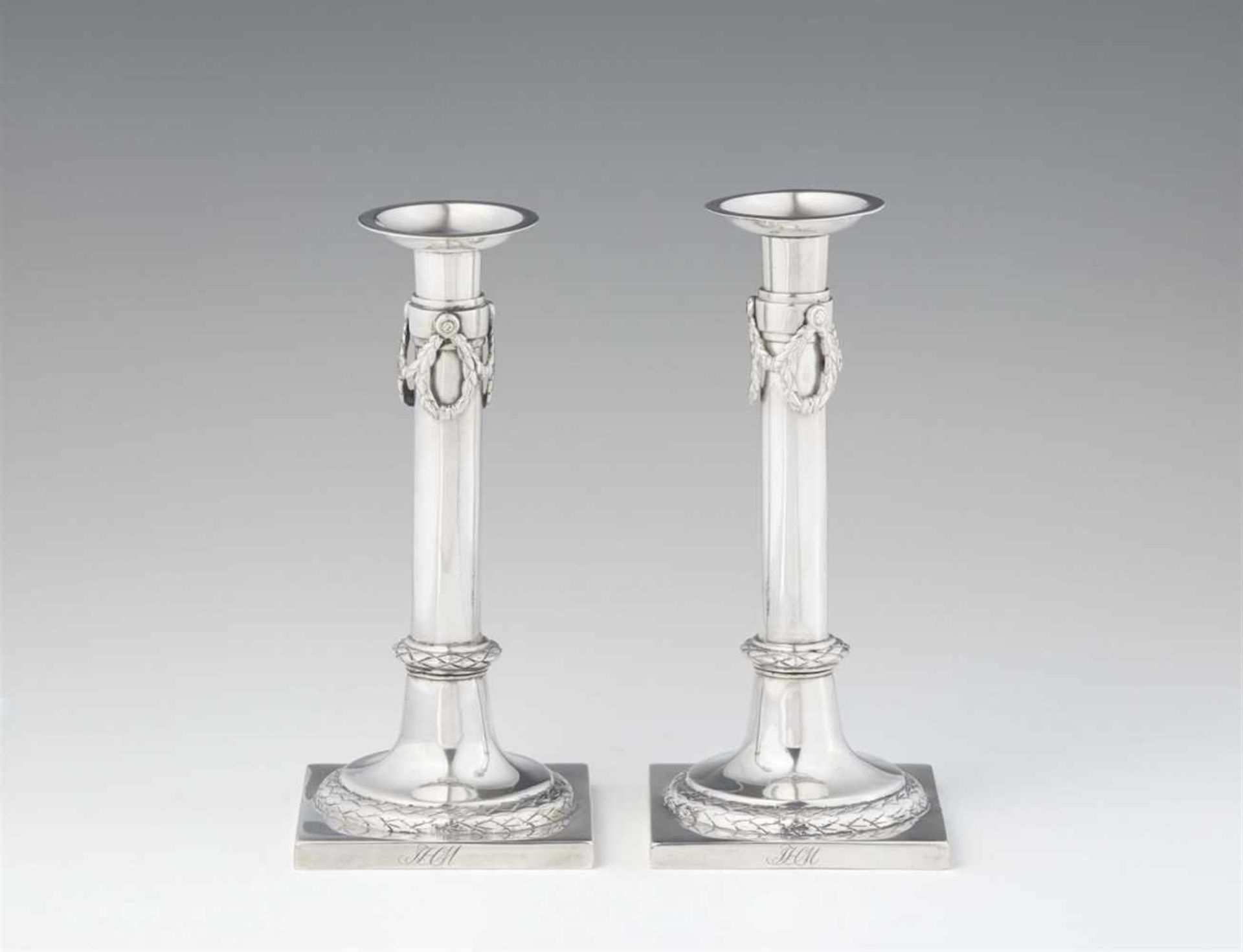 A pair of Brunswick silver candlesticksFestooned column shafts resting on square plinths. H 19.7 cm,