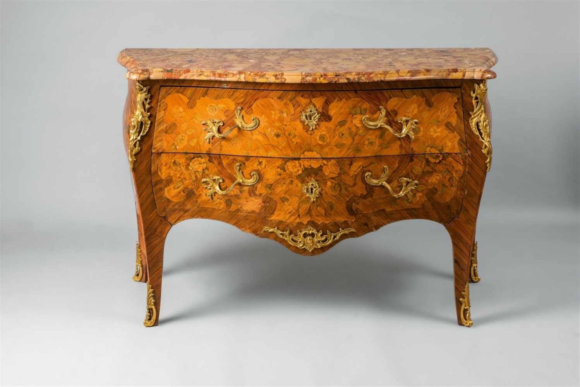 A Louis XV style chest of drawersPalisander, rosewood, maple, and stained wood on oak corpus, ormolu