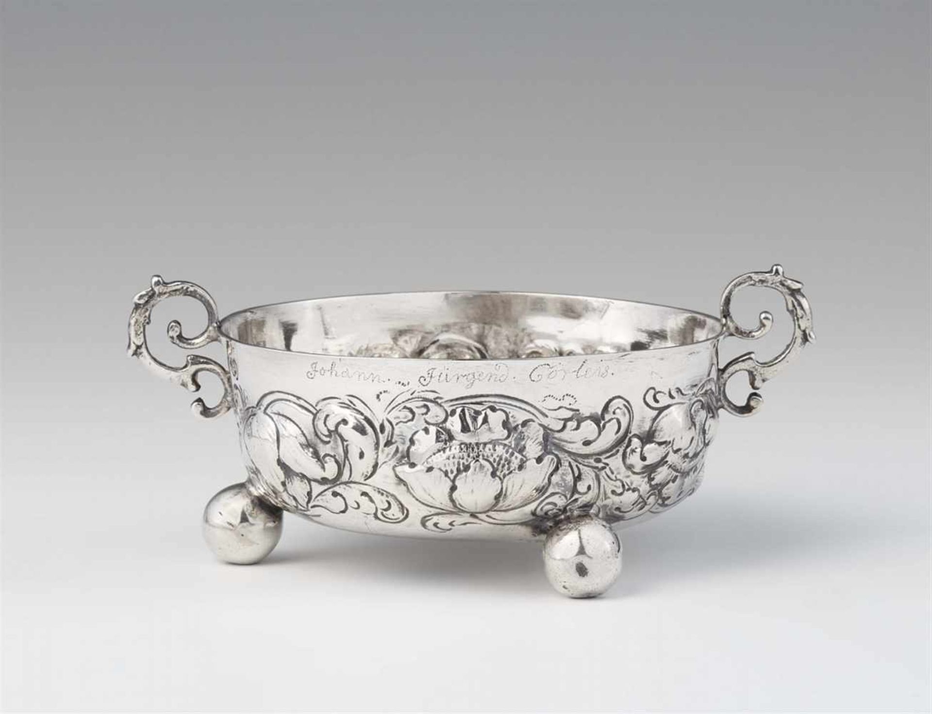 A Hamburg silver wine tasting dishShallow dish on three spherical supports, the surface decorated