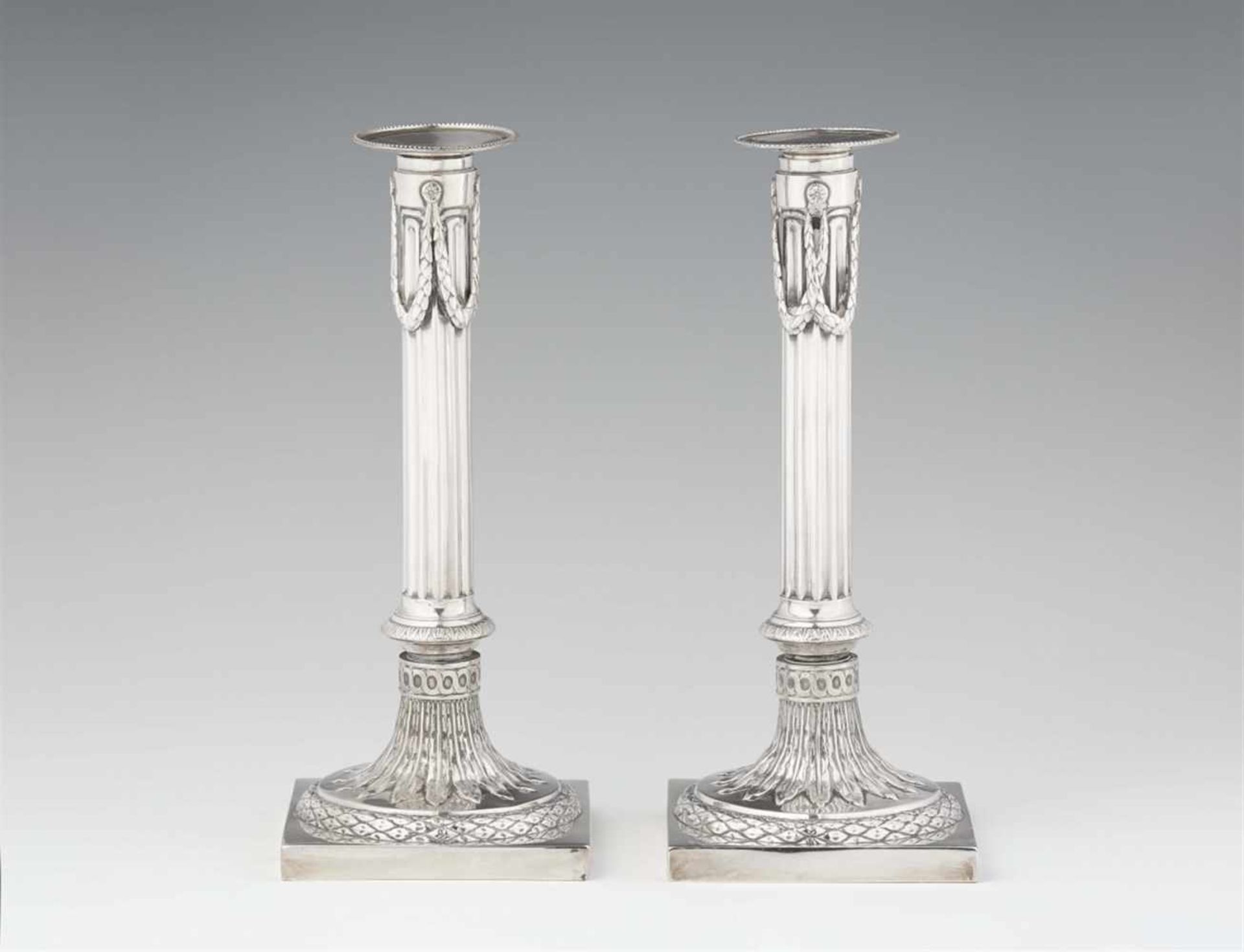 A pair of Mannheim silver candlesticksFluted shafts supported by square plinths. H 26 cm, weight 720