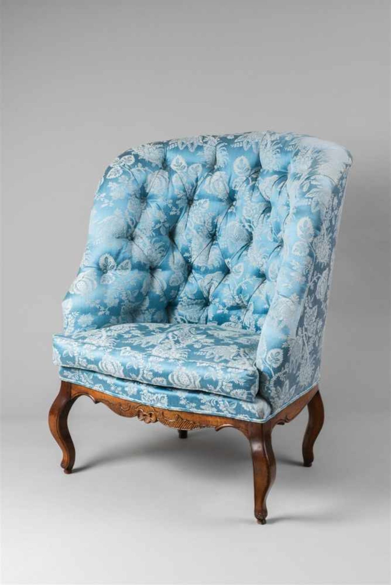 A South German fauteuil crapaudCarved walnut with modern damask upholstery. Restored. H 110, W 89, D