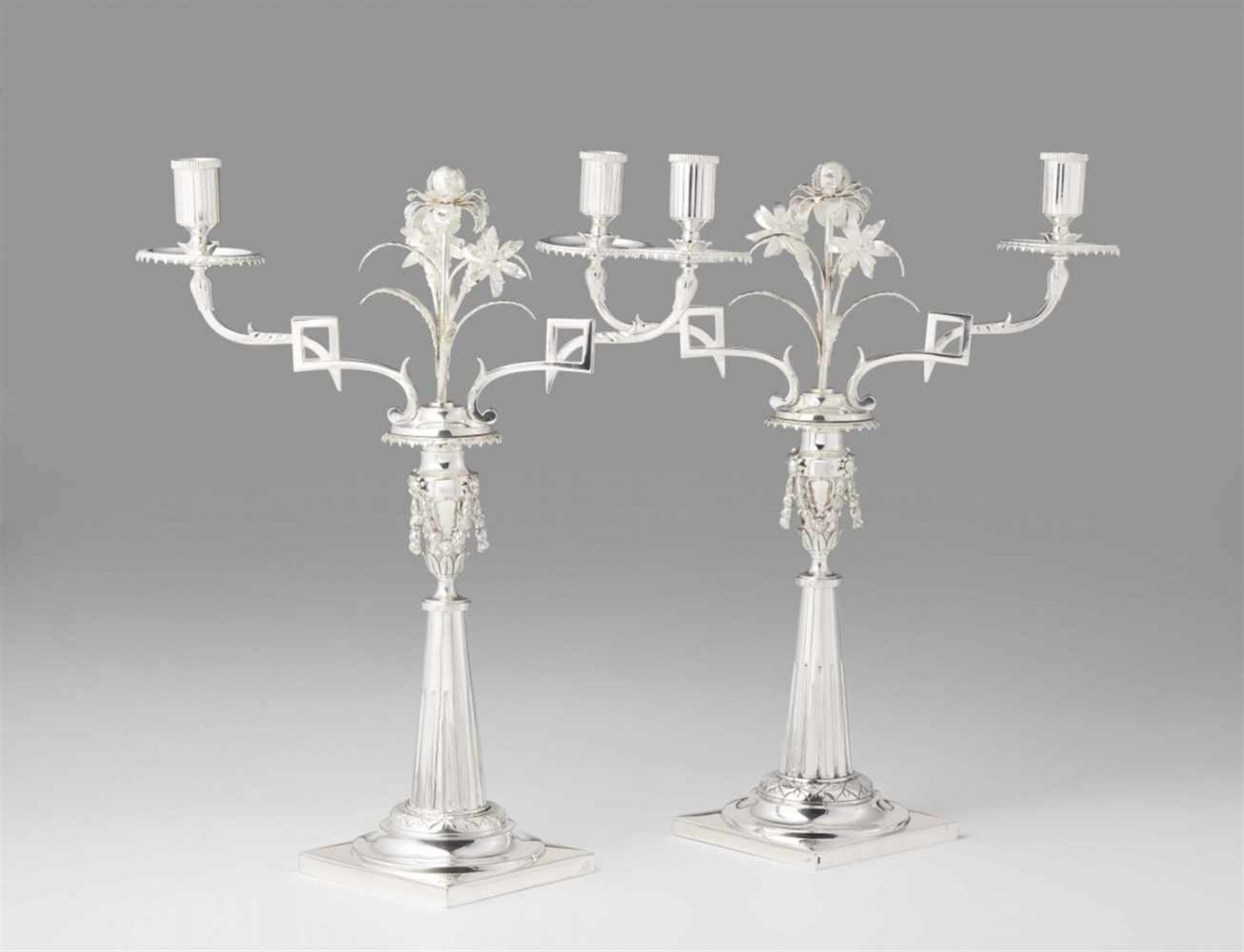 A pair of Augsburg silver candelabraTapering fluted shafts supported by square plinths with small