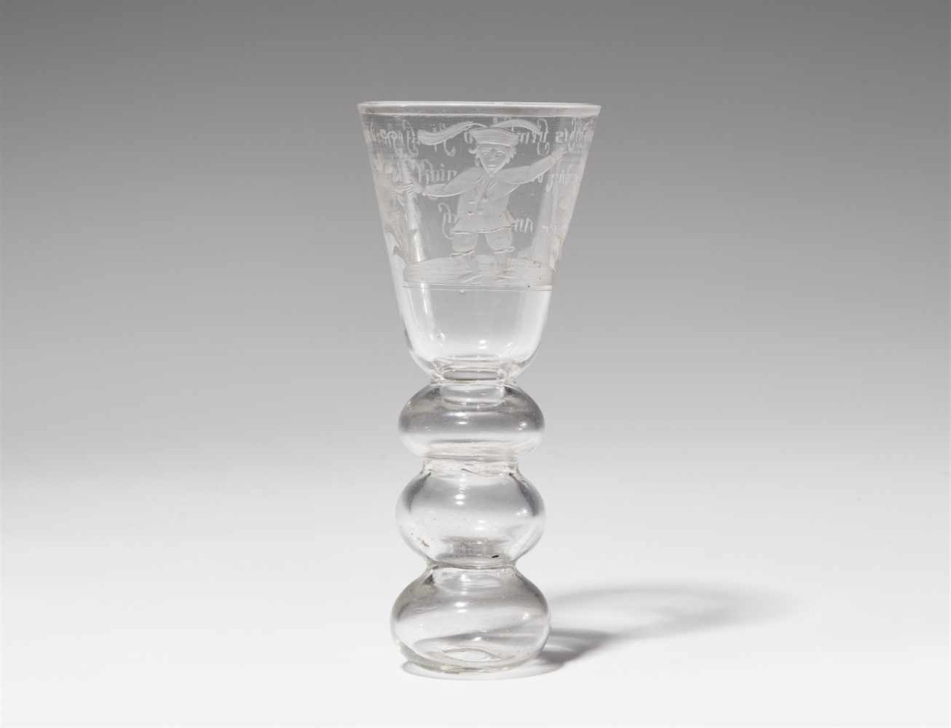 A cut glass beakerTapering cylindrical beaker with hollow shaft. The reverse engraved "Ey wie geth