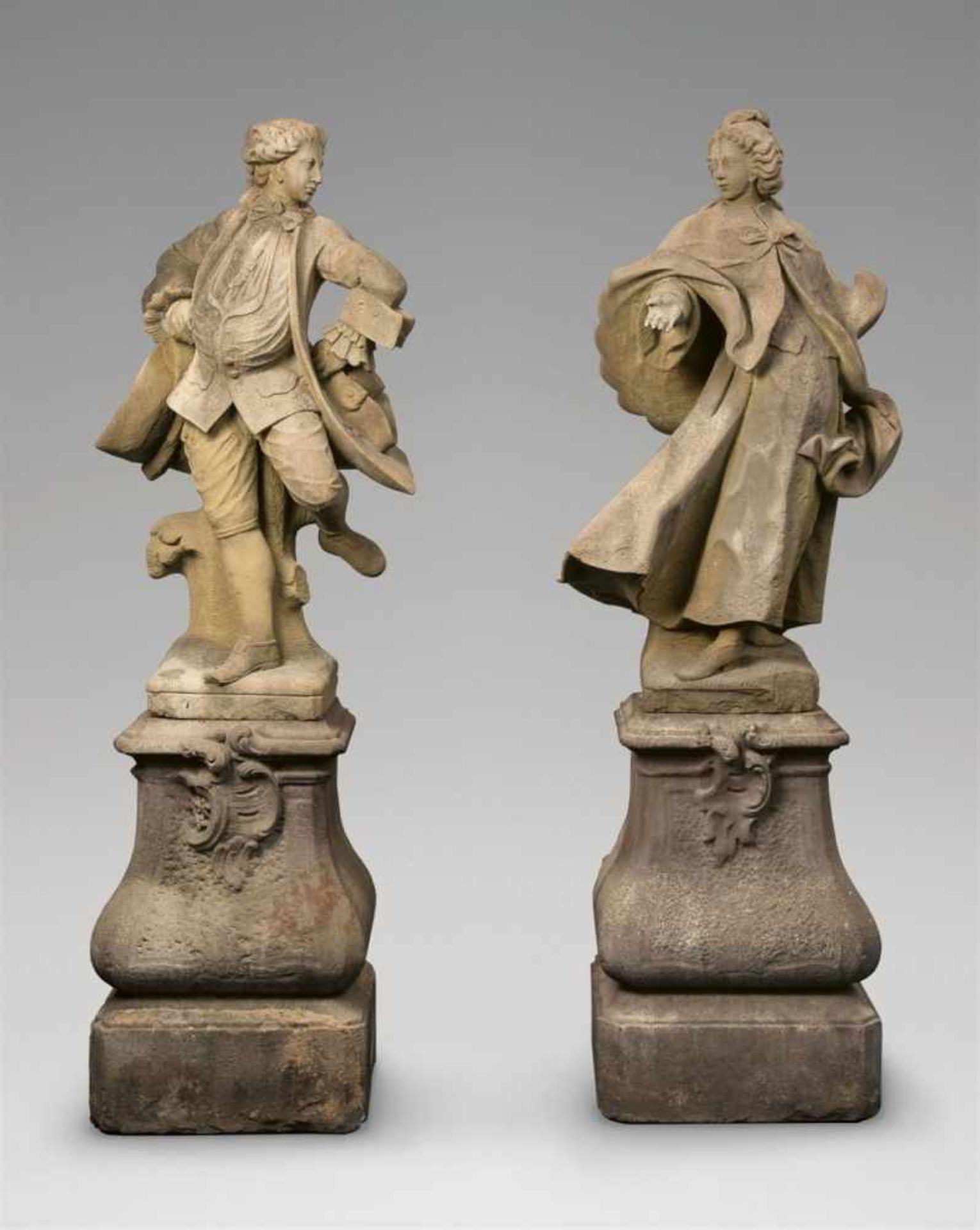 Sandstone models of an elegant couple dancingTwo figures on scrolling plinths, carved in the