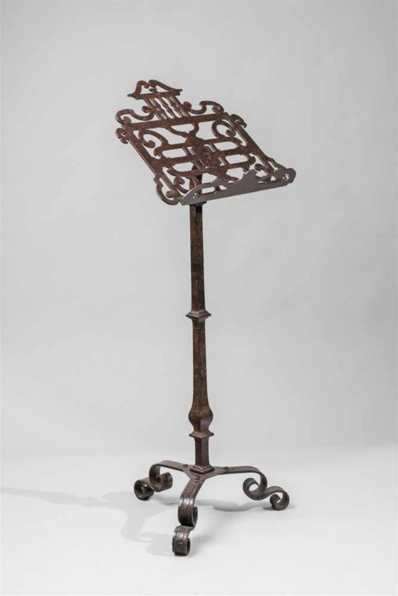 A North Italian wrought iron leggio baroccoLectern with pierced scrollwork reading surface supported