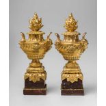 A pair of Transition era ormolu flame urnsCast in several parts comprising baluster form vases
